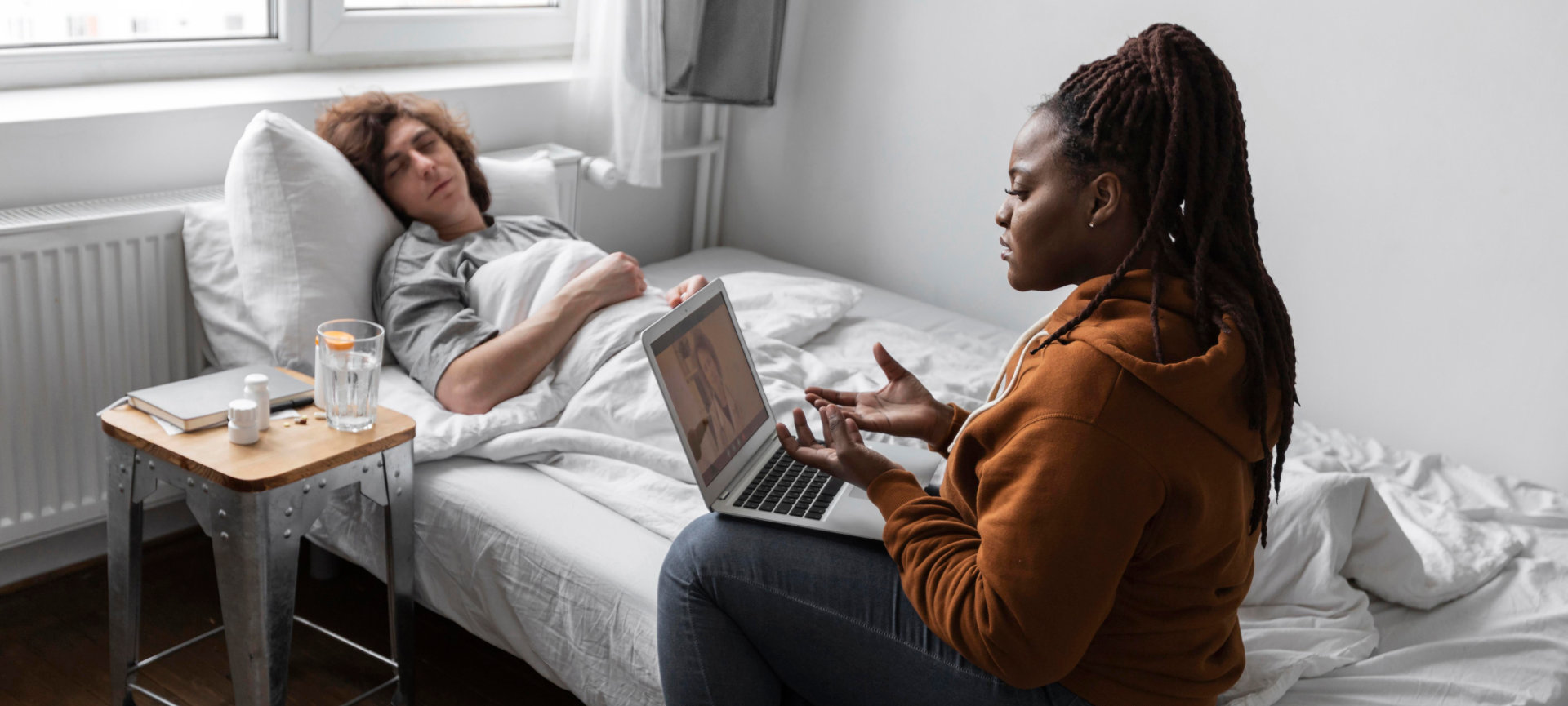 nurse on a laptop with patient 
